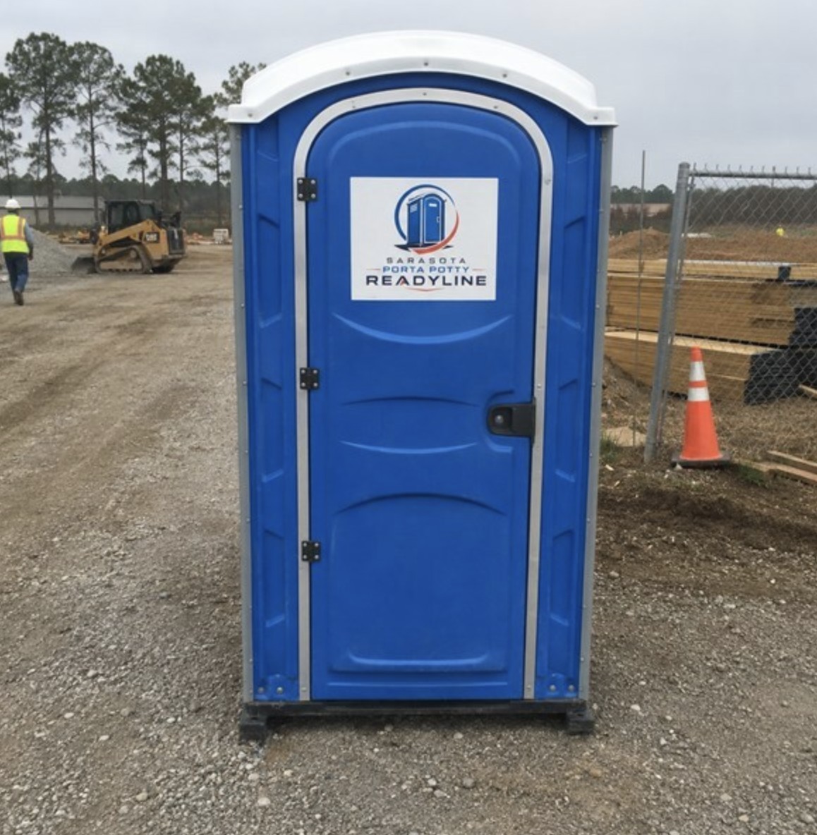 Blue porta potty rental at a Sarasota, FL construction site